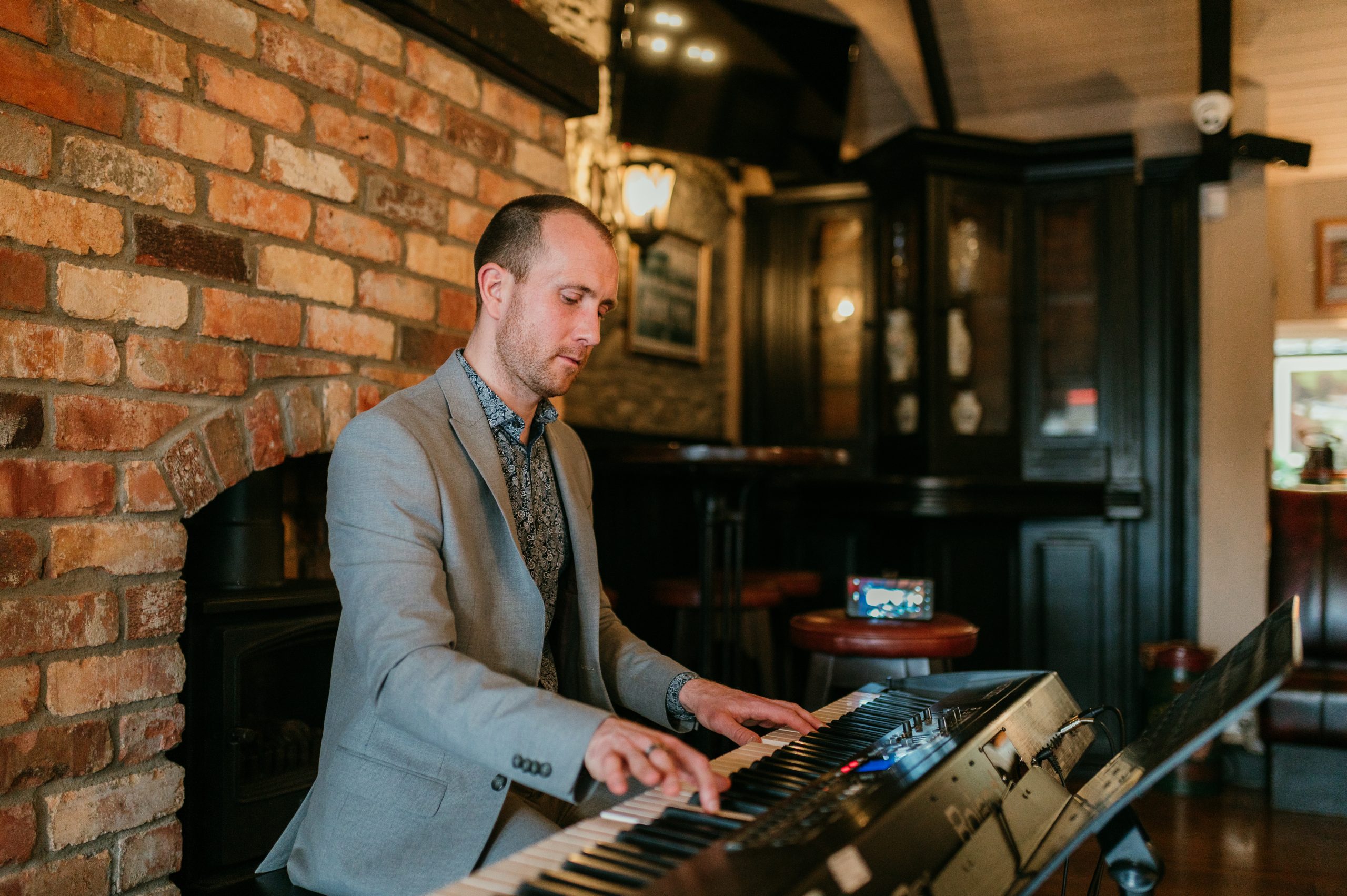 Joe Kenny pianist playing piano over a wedding drinks reception in Darver Castle, Co. Louth