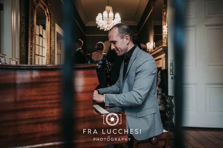 Joe Kenny playing baby grand piano In Tankardstown House Co Meath