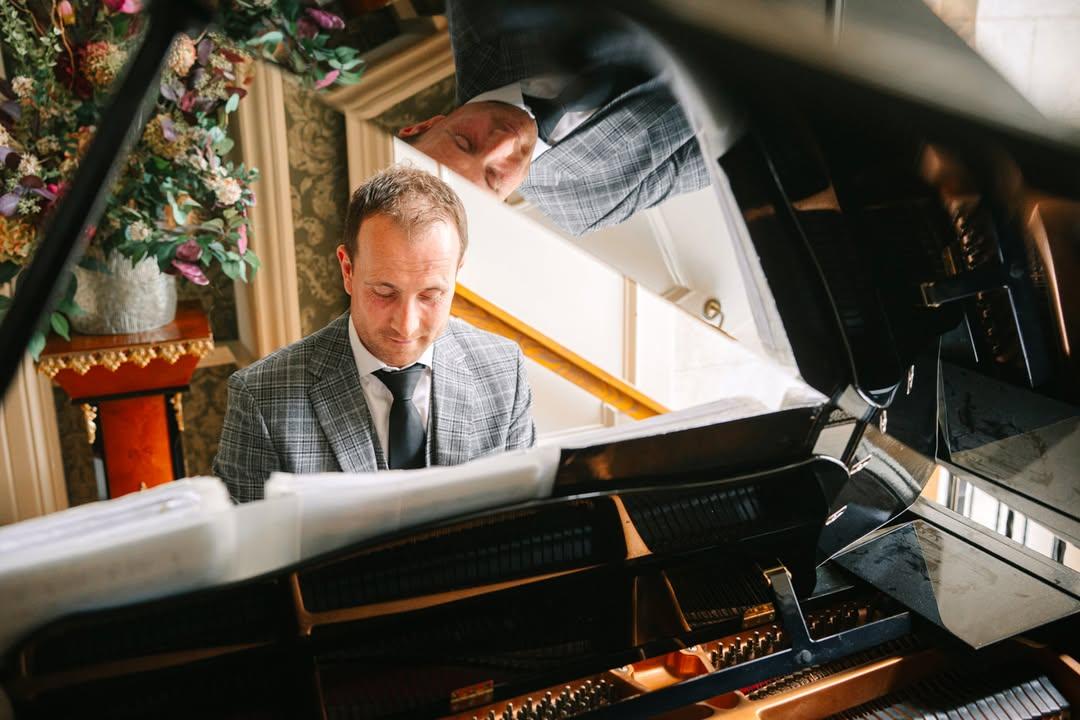 Joe Kenny playing baby grand piano In Tankardstown House Co Meath