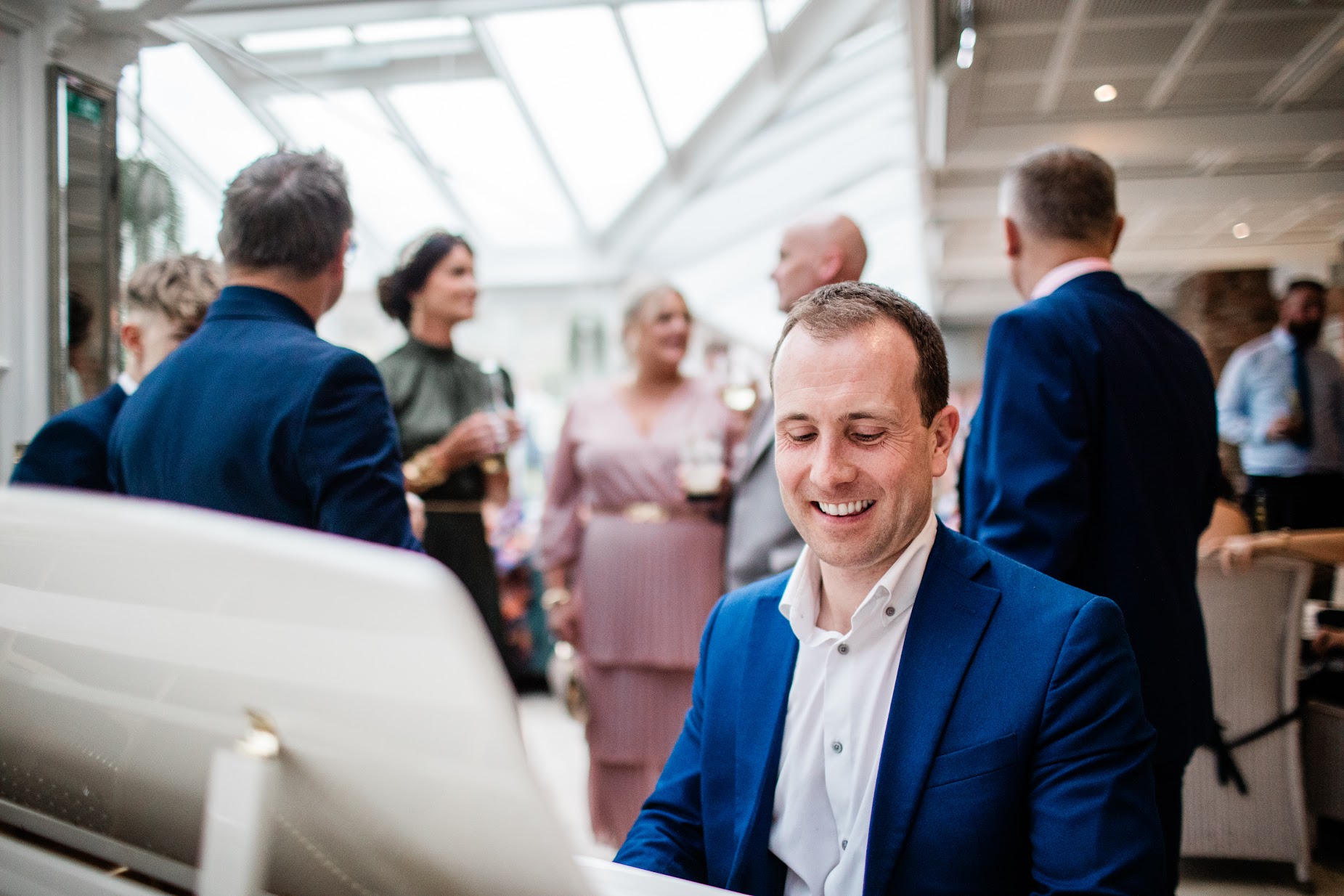 Joe Kenny pianist playing piano over a wedding drinks reception in Ballymagarvey Village, Co. Meath