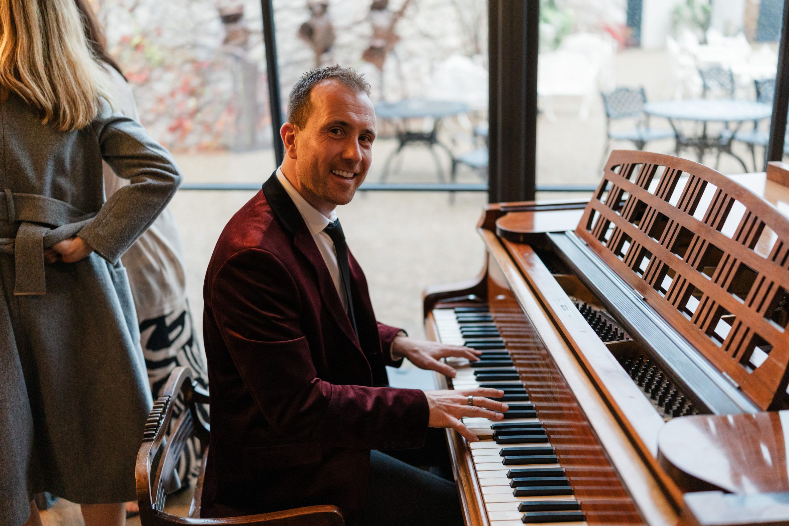 Joe Kenny pianist playing piano over a wedding drinks reception in Clonabreany House, Co. Meath